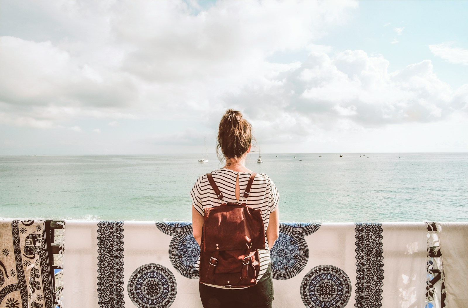 woman standing in front of body of water during daytime