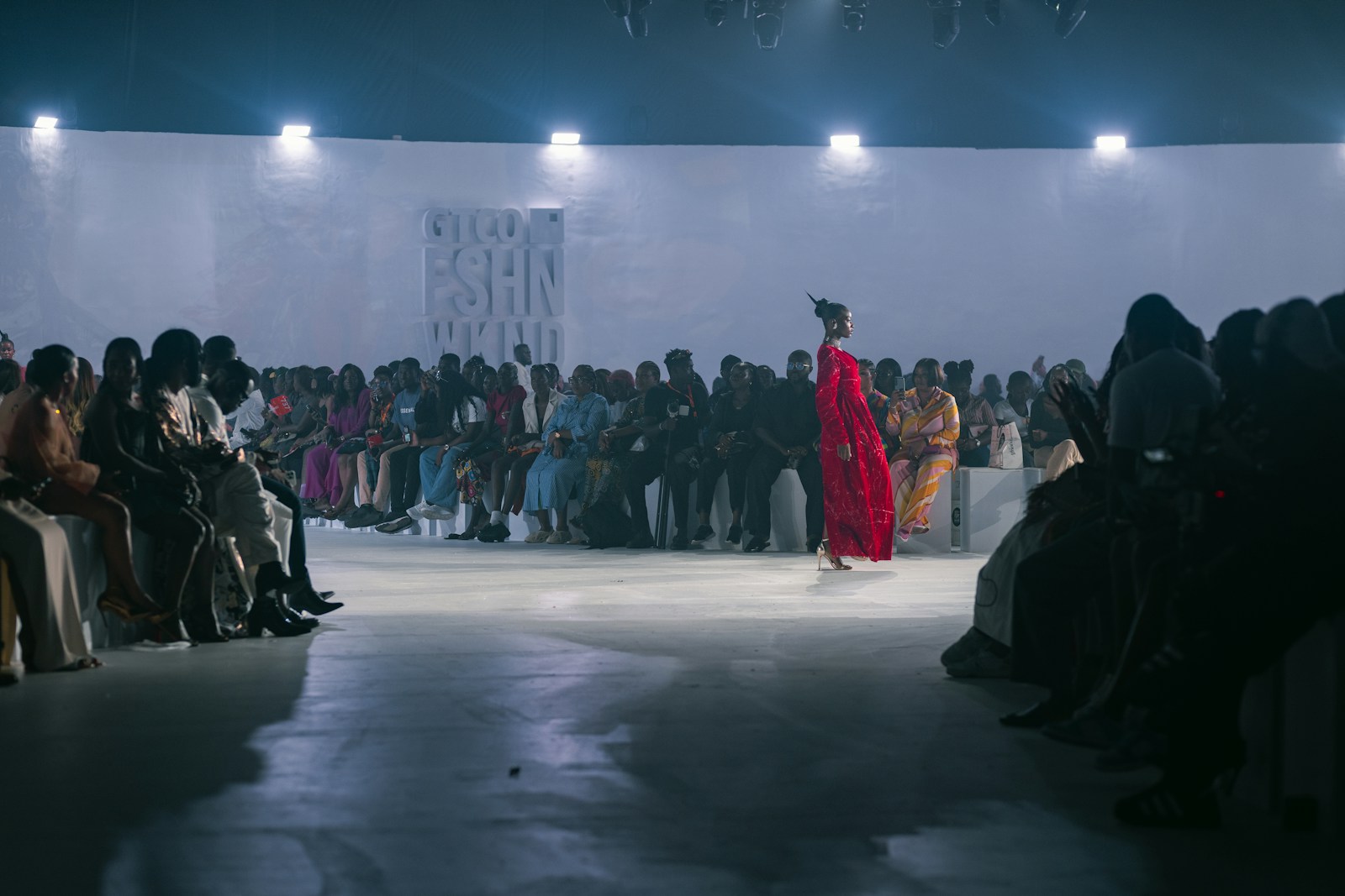 A group of people watching a fashion show