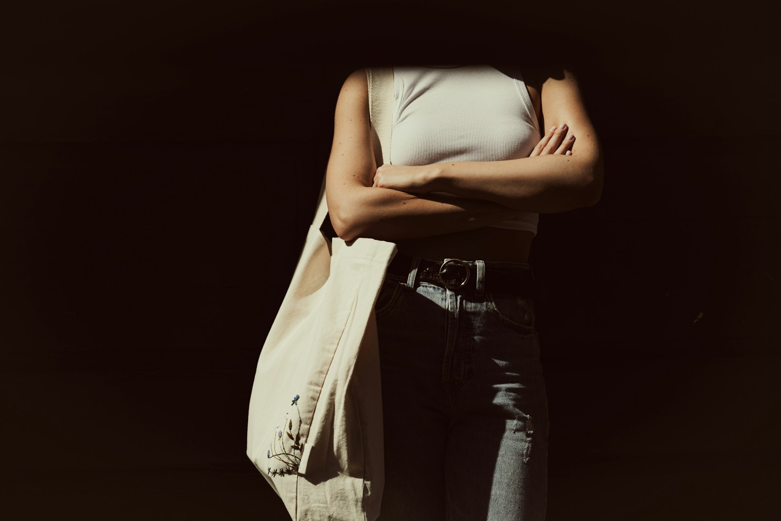 a woman is standing with her arms crossed
